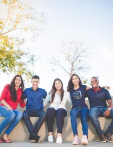 friends sitting and holding one another showing love in Katy, TX