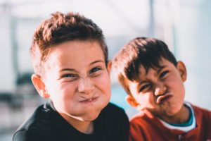 Two little boys making silly faces after their family counseling session in Katy, TX