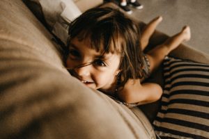 Little girl smiling and happy after her parents learned better parenting skills in therapy 