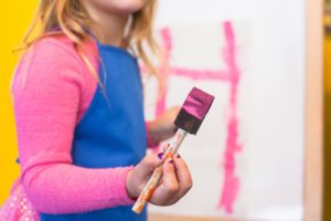 Little girl painting during her family therapy session in Katy, TX