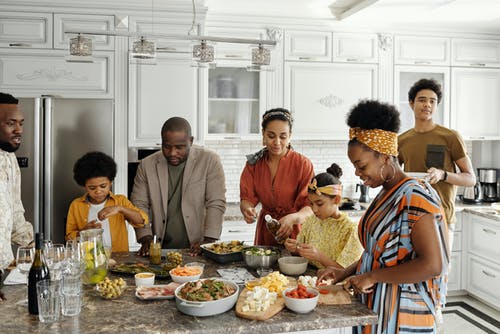 A big family hanging around in the kitchen talking and maintaining healthy relationships with one another. This family has been resolving their difference with family therapy in Katy, tx. There is no need to make therapy for families stressful. Locke Counseling and Consulting wants to help you find peace and connection. Call now!