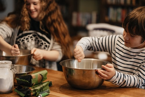 Two kids cooking in the kitchen. Represents the need for family counseling to help parenting children with ADHD in Katy, TX 77494