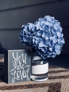 A vase with blue flowers and a sign that read you are loved. Represents the need for couples therapy to help make the relationship exciting in Katy, TX 